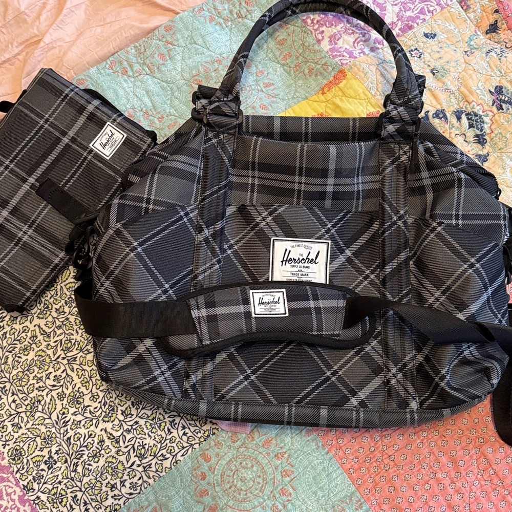 Herschel diaper bag with changing mat in black plaid. NEW